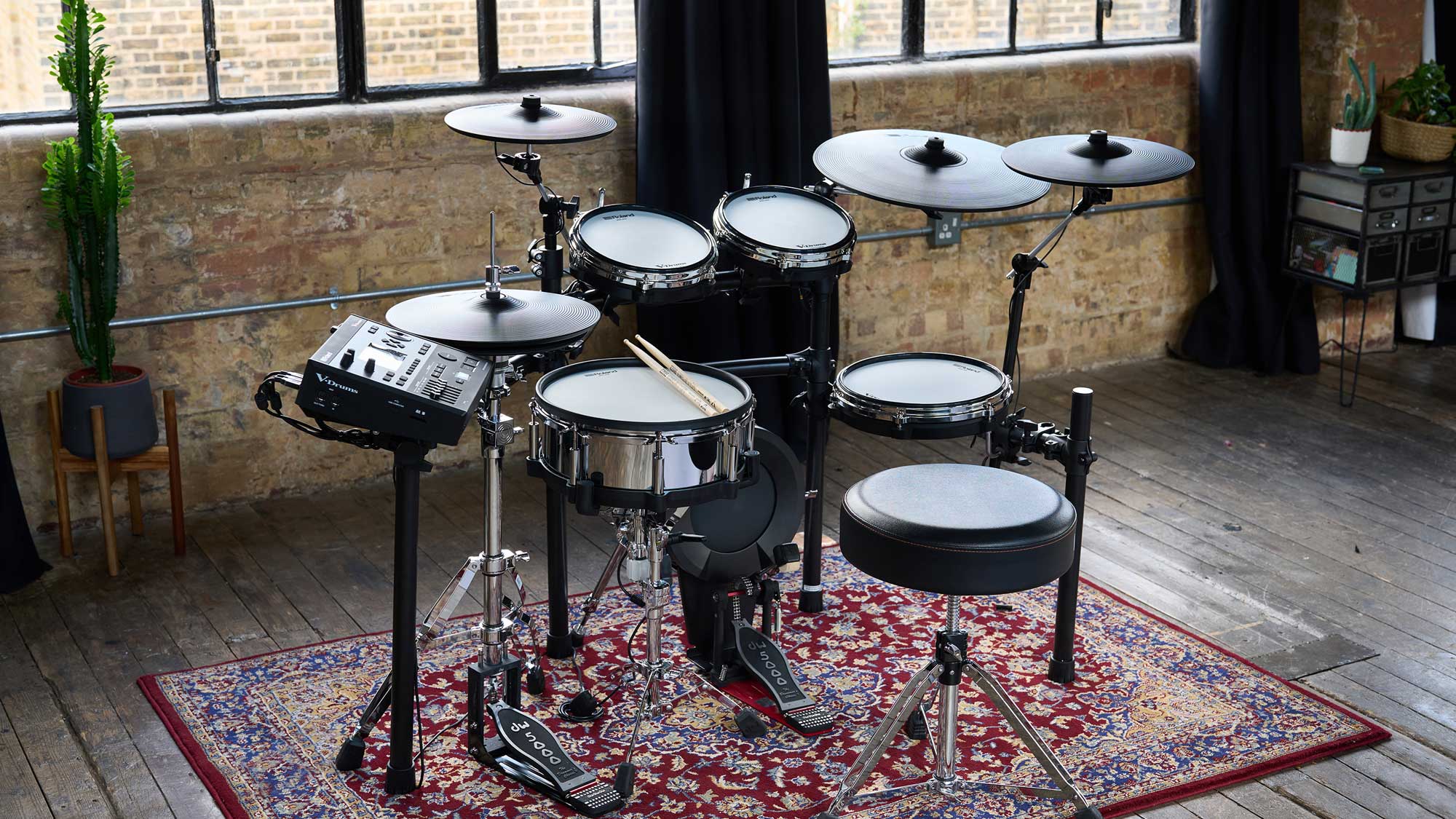Roland TD516 V-Drums electronic drum set in a room with large windows and plants