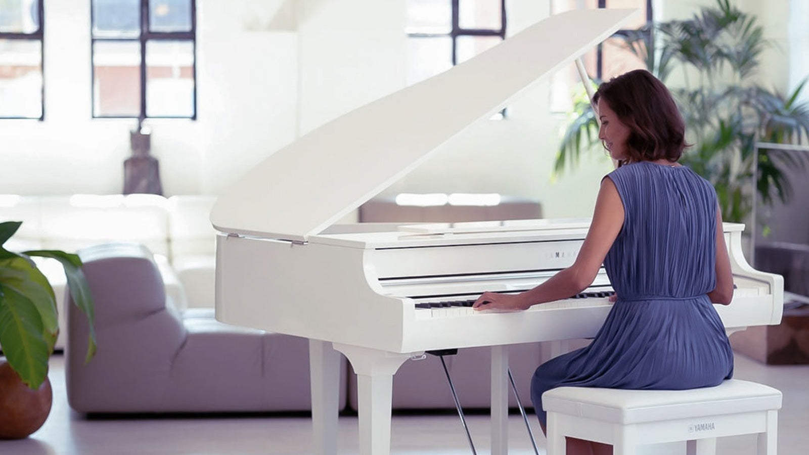 Woman playing a Clavinova grand piano