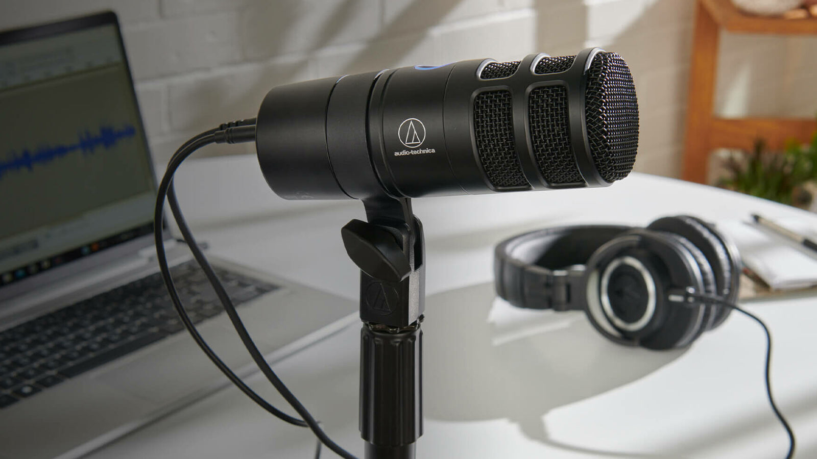 An Audio-Technica microphone in a podcasting studio