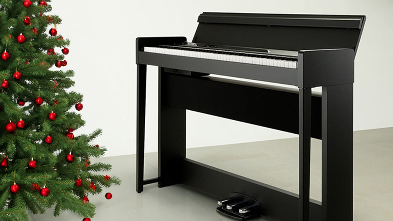 A Korg digital piano next to a decorated tree