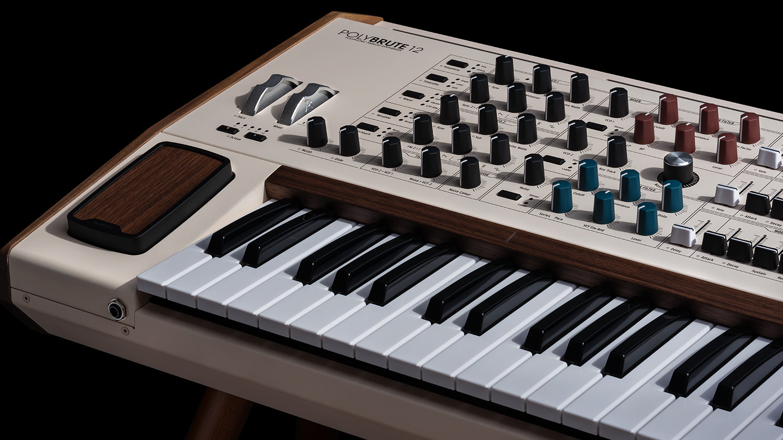 Detail view of PolyBrute 12 showing Morphee pad, expression wheels, control knobs, and keyboard