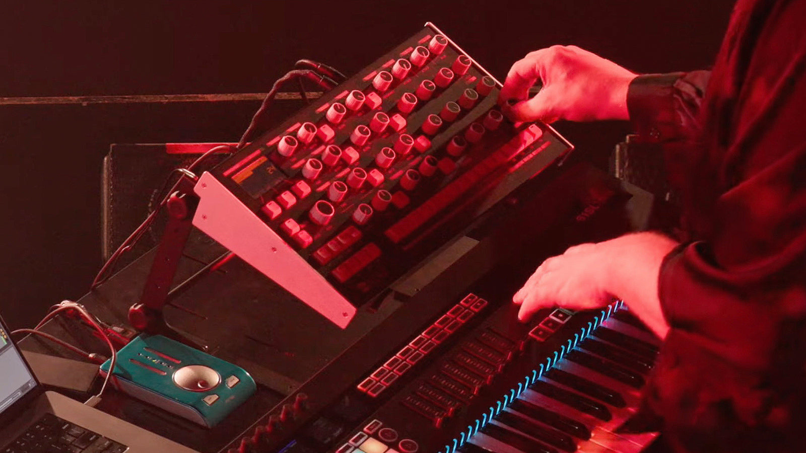 Someone playing a Melbourne Instruments synth on stage