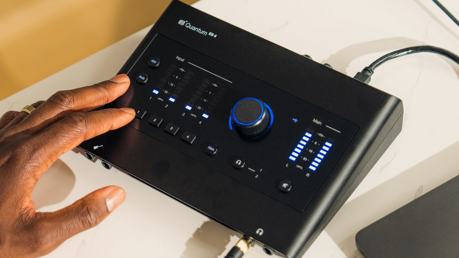 A PreSonus Quantum ES4 on a shelf in a studio