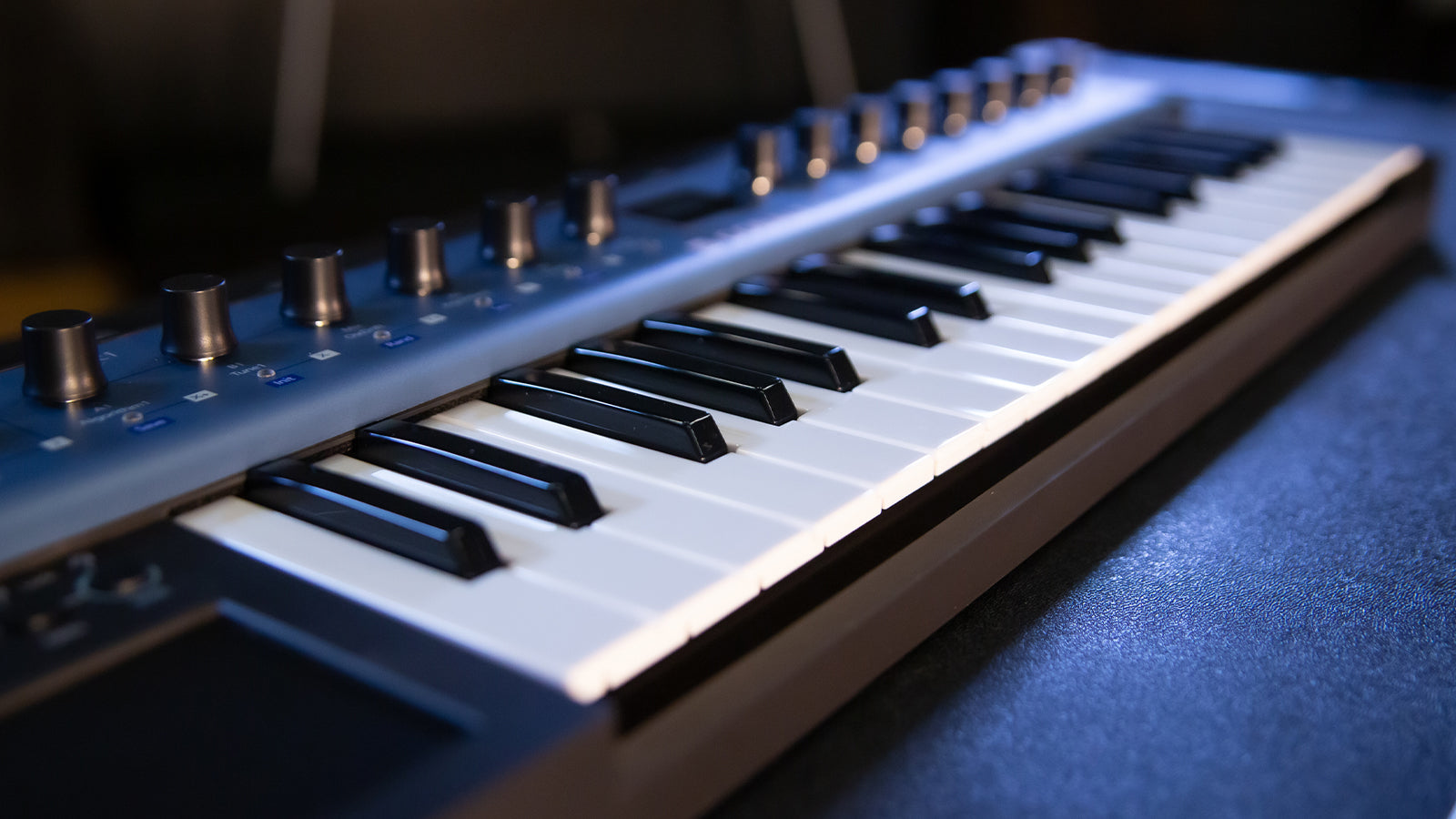 A Modal synth resting on a road case in a studio