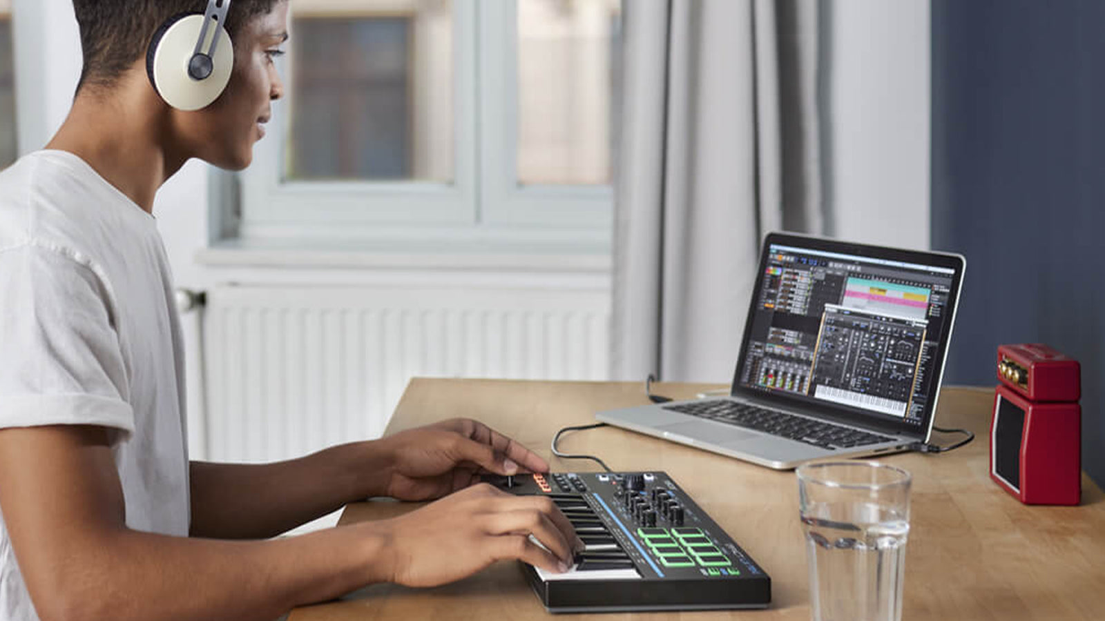 A young man operating a Nektar controller