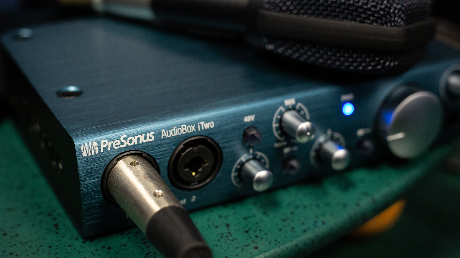 A Presonus interface on a desk in a home studio