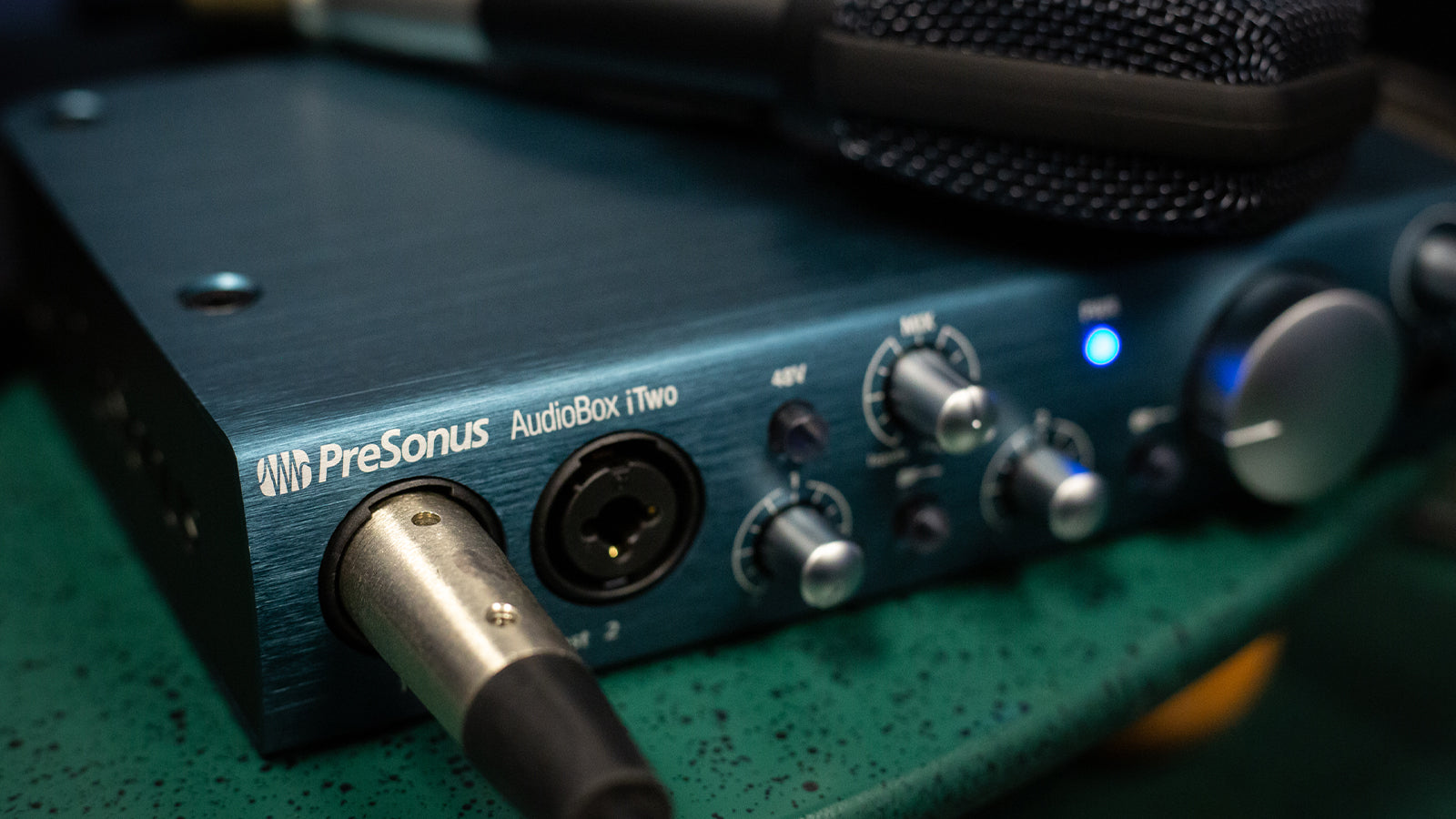 A Presonus interface on a desk in a home studio