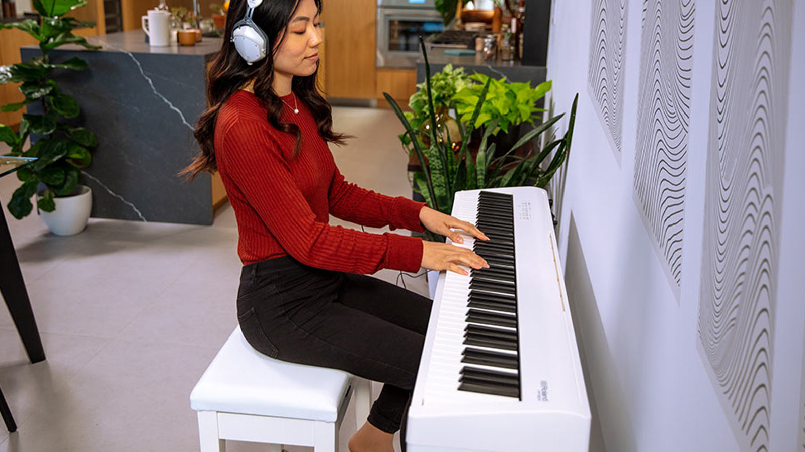A young lady playing a Roland FP-30X