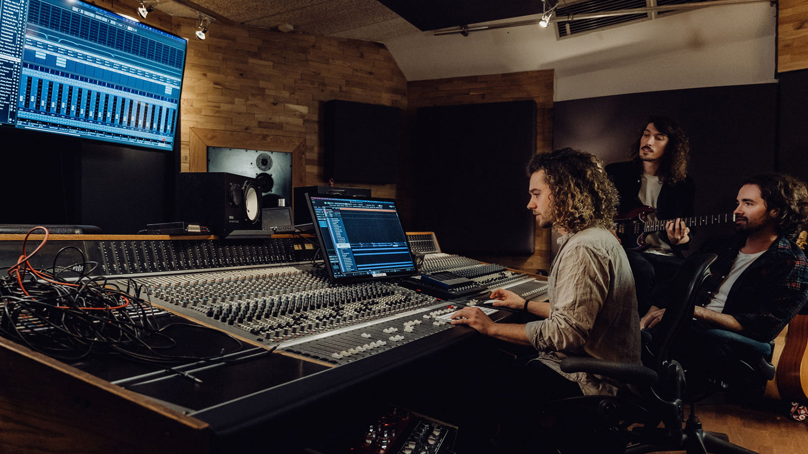 A few young men using Steinberg Cubase in a professional recording studio