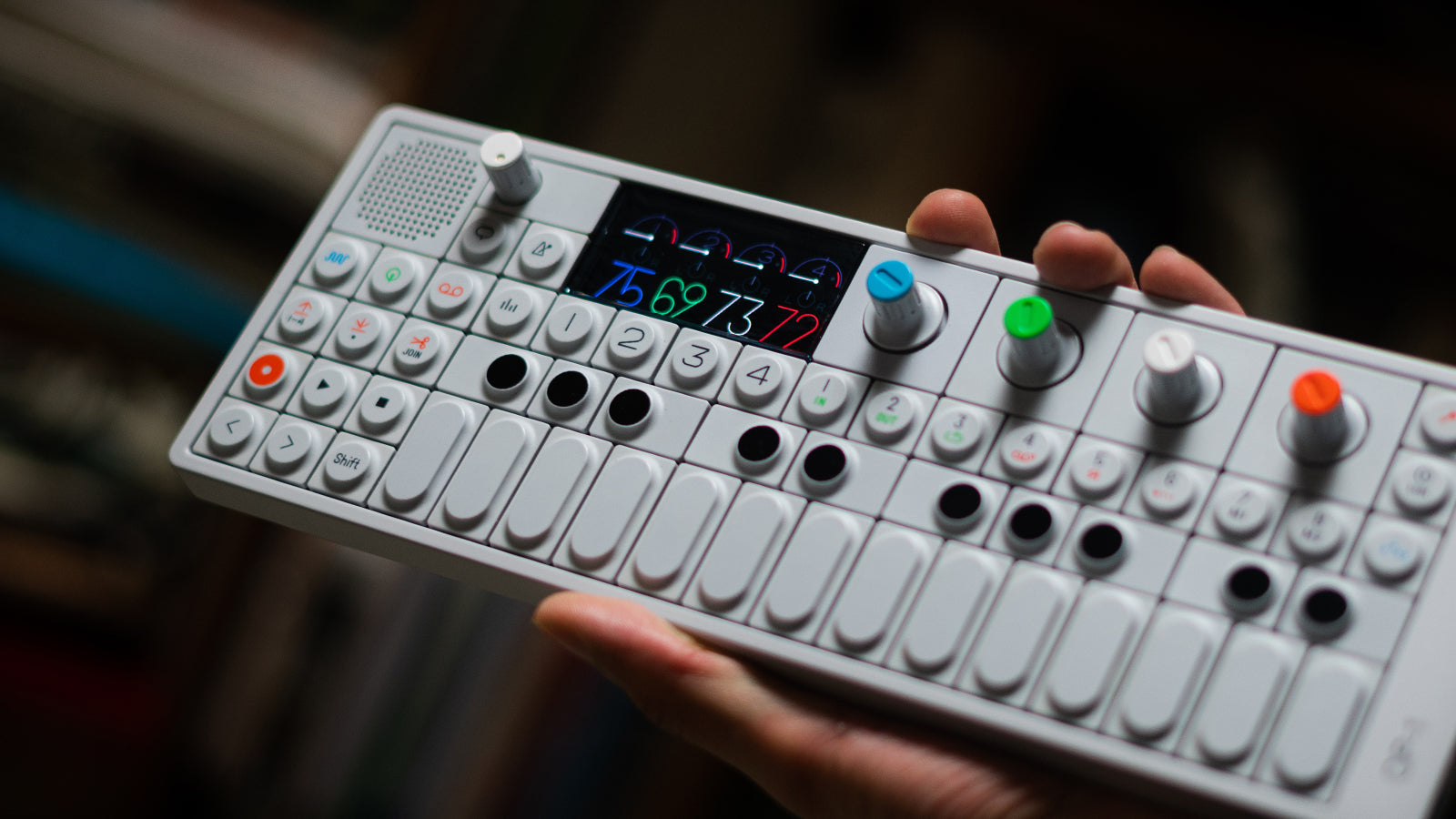 A man holding a TE portable synth