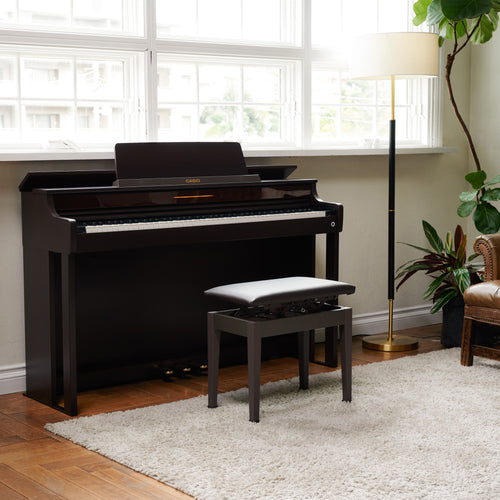 Casio Celviano AP-550 Digital Piano - Brown - facing right in a stylish living space