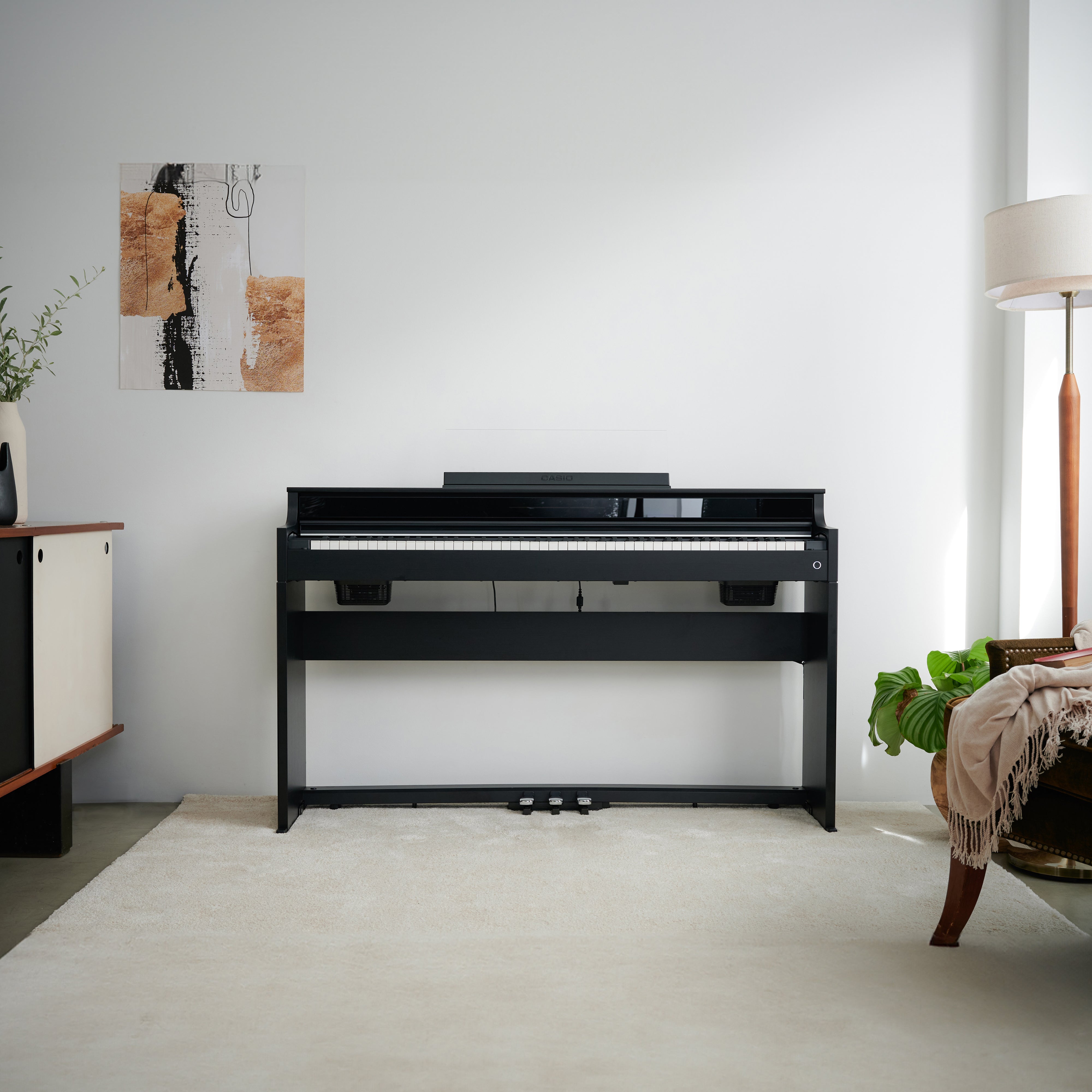 Casio Celviano AP-S450 Digital Piano - Black - front view in a stylish room