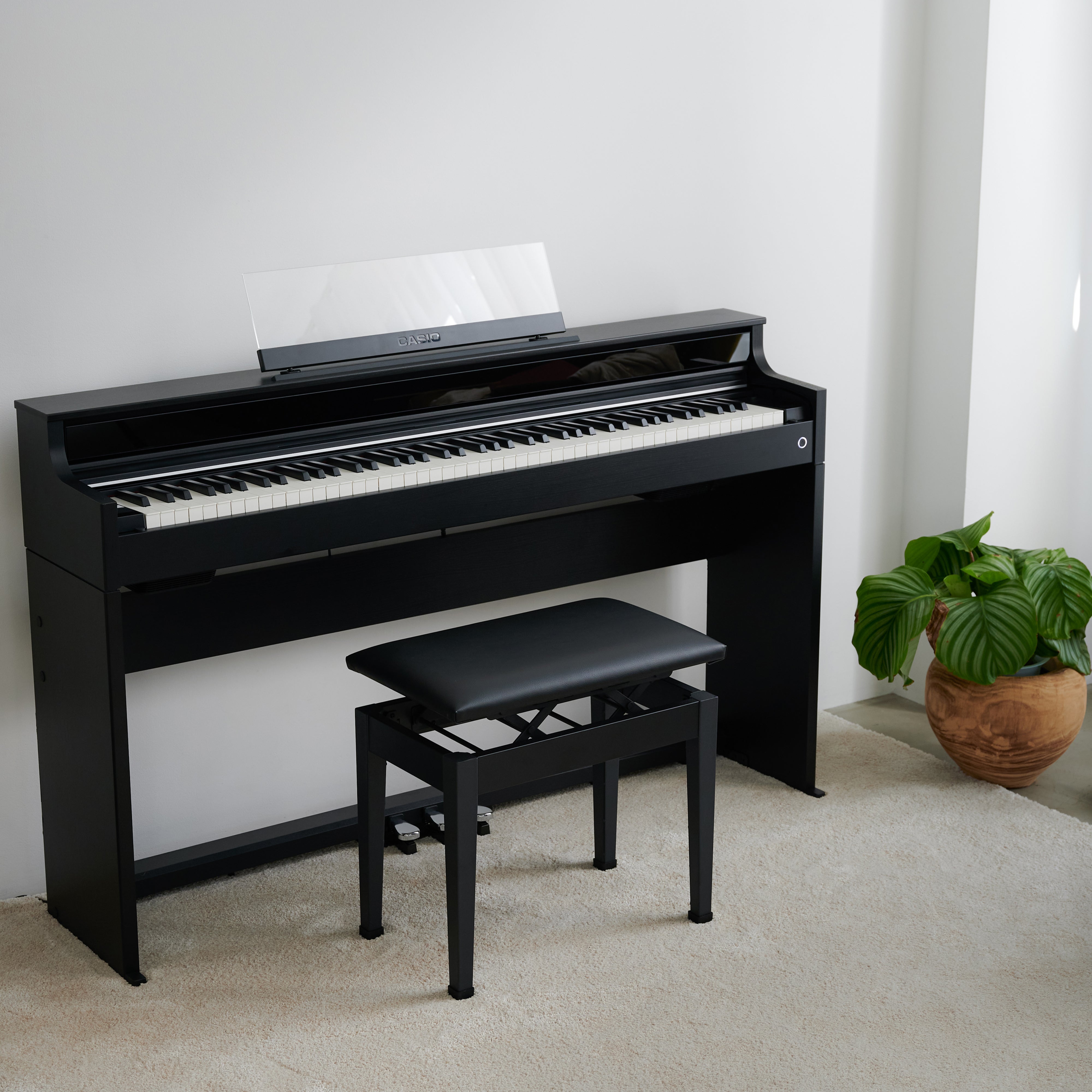 Casio Celviano AP-S450 Digital Piano - Black - facing right in a stylish living space