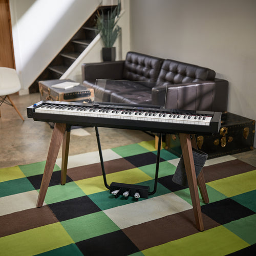 Casio PX-S7000 Digital Piano - Black in a stylish room