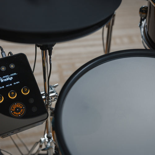Overhead view of Gretsch Catalina EVO drum module with OLED display beside snare pad