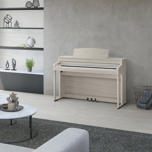 Kawai CA501 Concert Artist Digital Piano in a modern living room setting with shelves and decor.