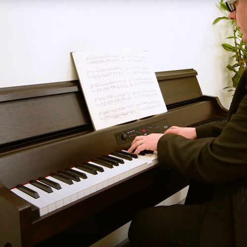 A gentleman playing a Korg G1B Air Digital Piano