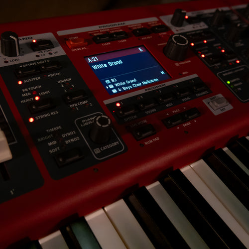 A close-up of a Nord Electro 7 with a small illuminated screen