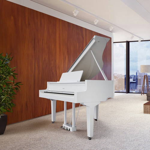 Roland GP-9 Digital Grand Piano - Polished White in a room with large windows and a cityscape view