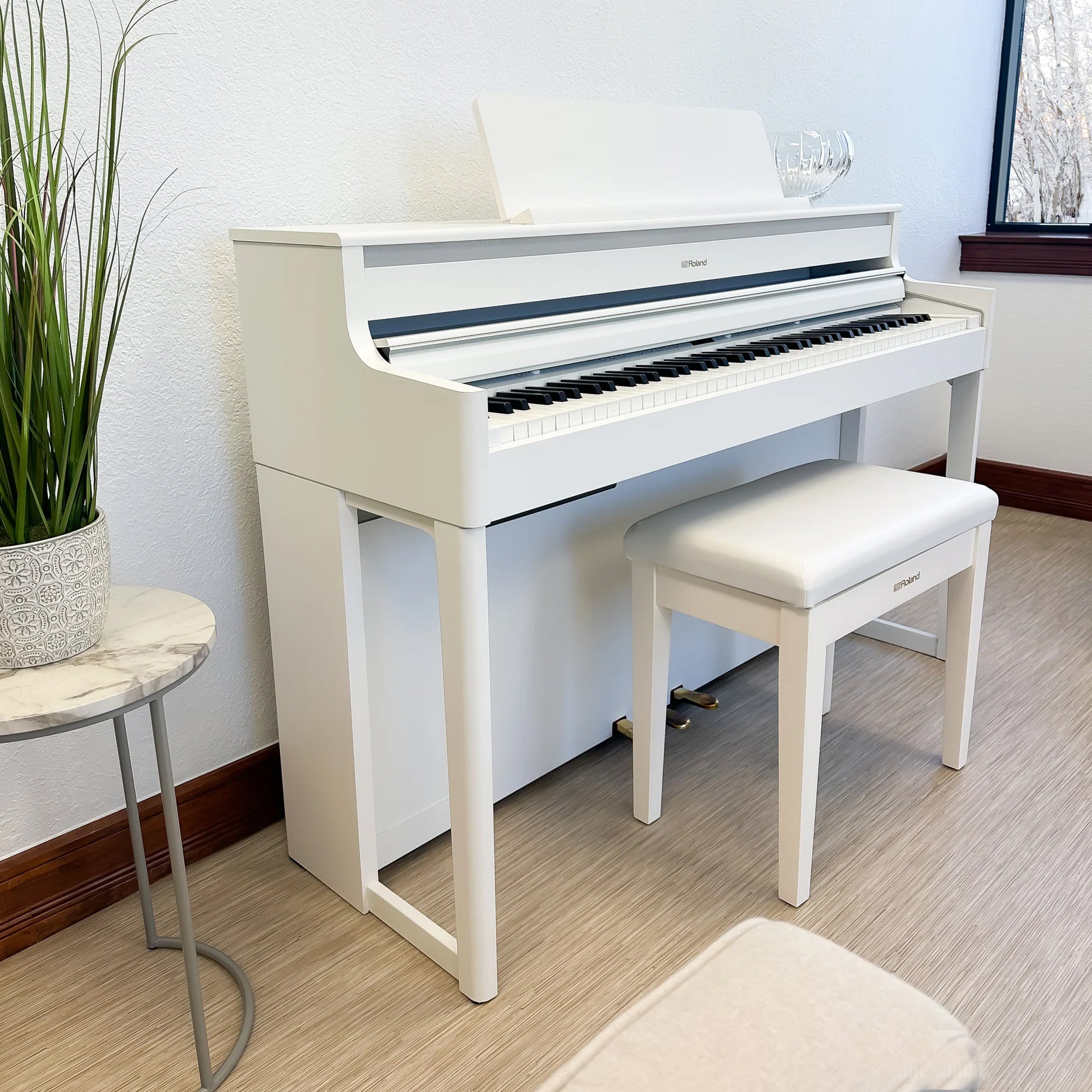 Roland HP704 Digital Piano - Satin White - in a stylish living room