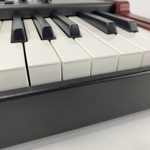 close of of the from panel of the instrument, there are some light scratches in the back metal panel below the keybed