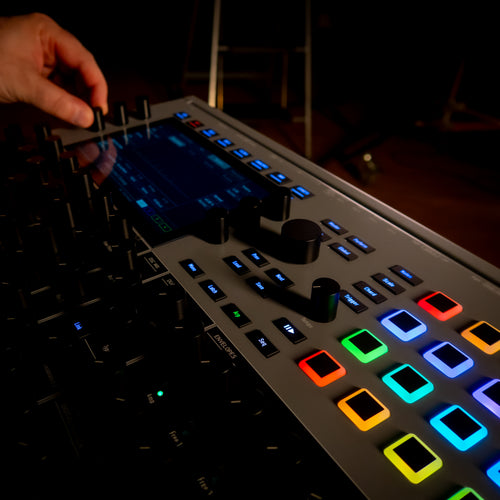 Waldorf Iridium MK2 being adjusted by a hand in a dark setting
