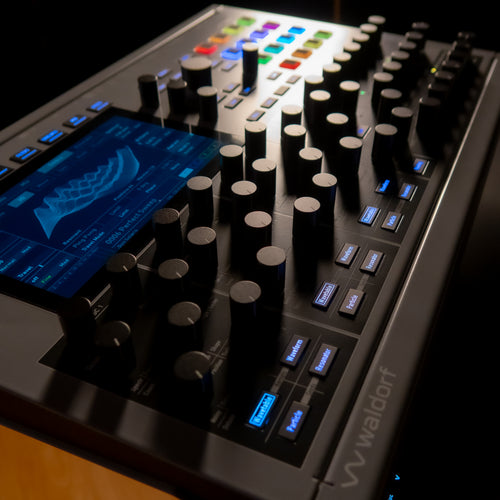 Waldorf Iridium MK2 on a stand in a dark lit studio