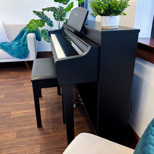 Yamaha Clavinova CSP-255 Digital Piano in a stylish living room - side view