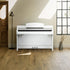 Yamaha Clavinova CSP-275 Digital Piano - Matte White - front view in a stylish living space