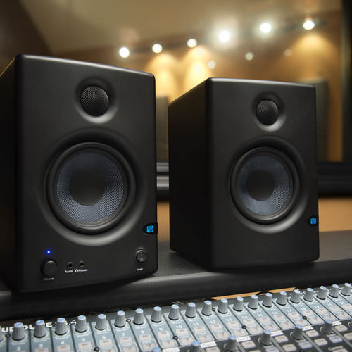 presonus eris e4.5 powered studio monitor speakers on console