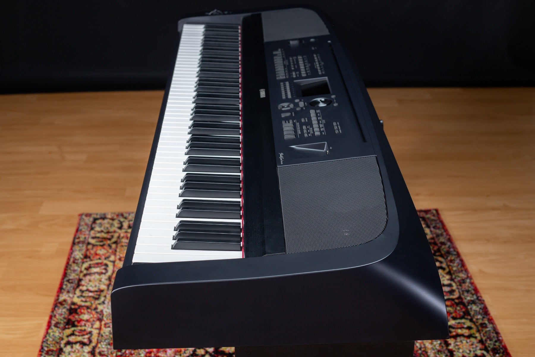 Side view of the Yamaha DGX-670 on a stylish rug