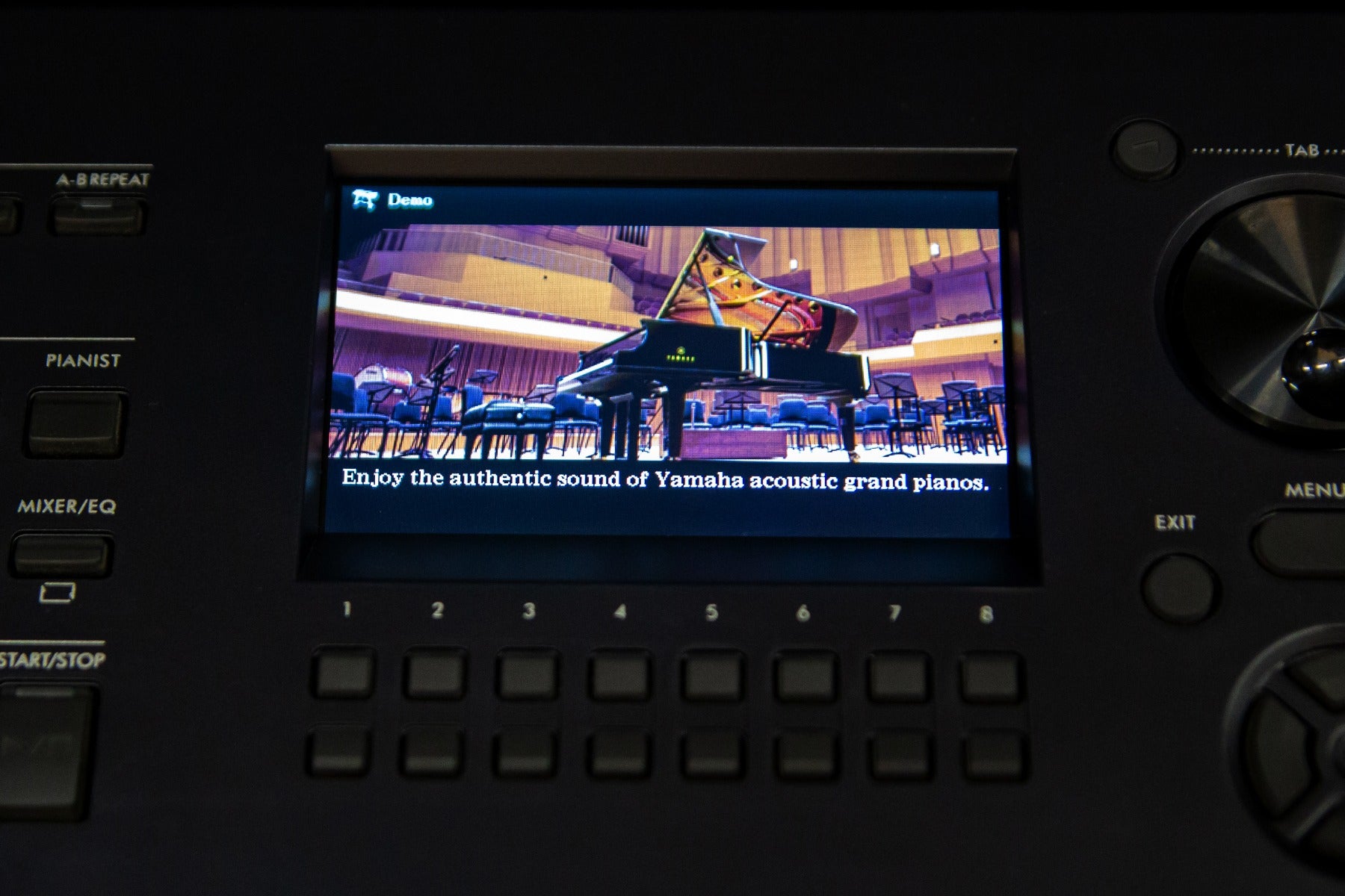 Close up of the Yamaha DGX-670 control panel showing the acoustic piano option on the screen