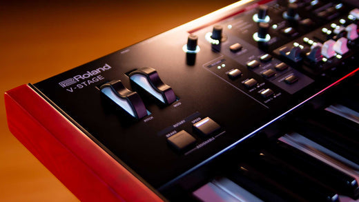 Closeup on Roland V-Stage keyboard showing logo and pitch/mod wheels