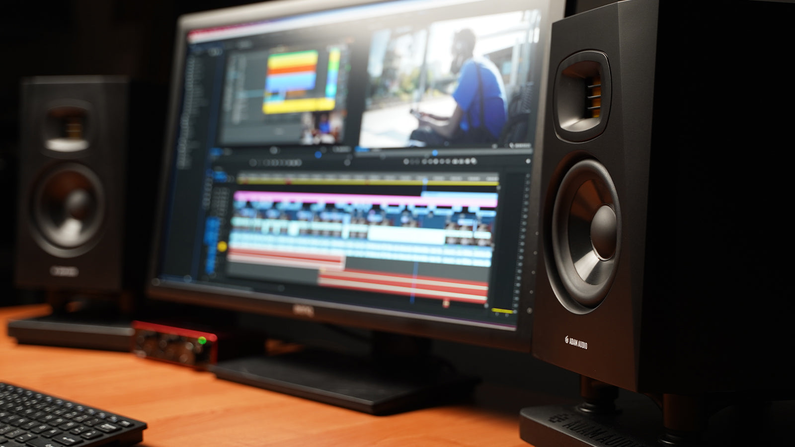ADAM Audio T Series monitors on a desk in a studio