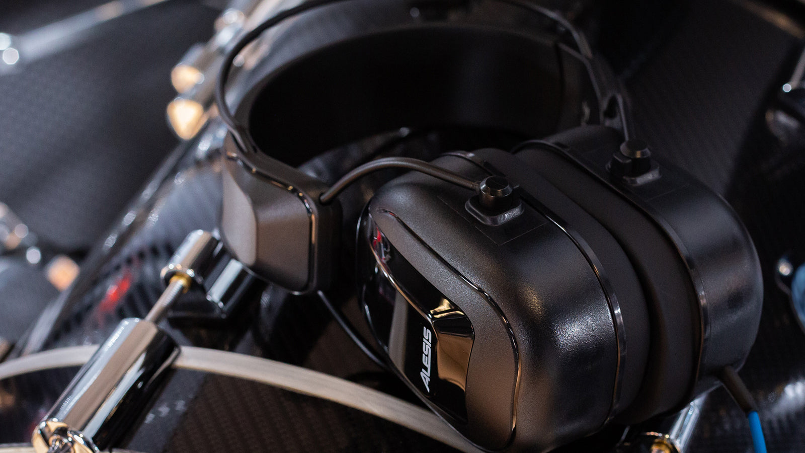Alesis headphones resting on a bass drum