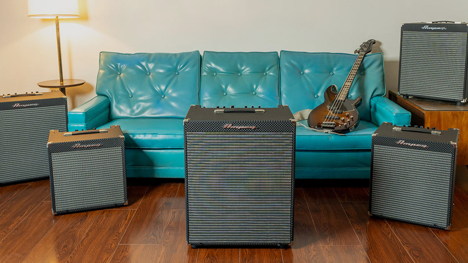 A group of Ampeg amps in a retro style living room