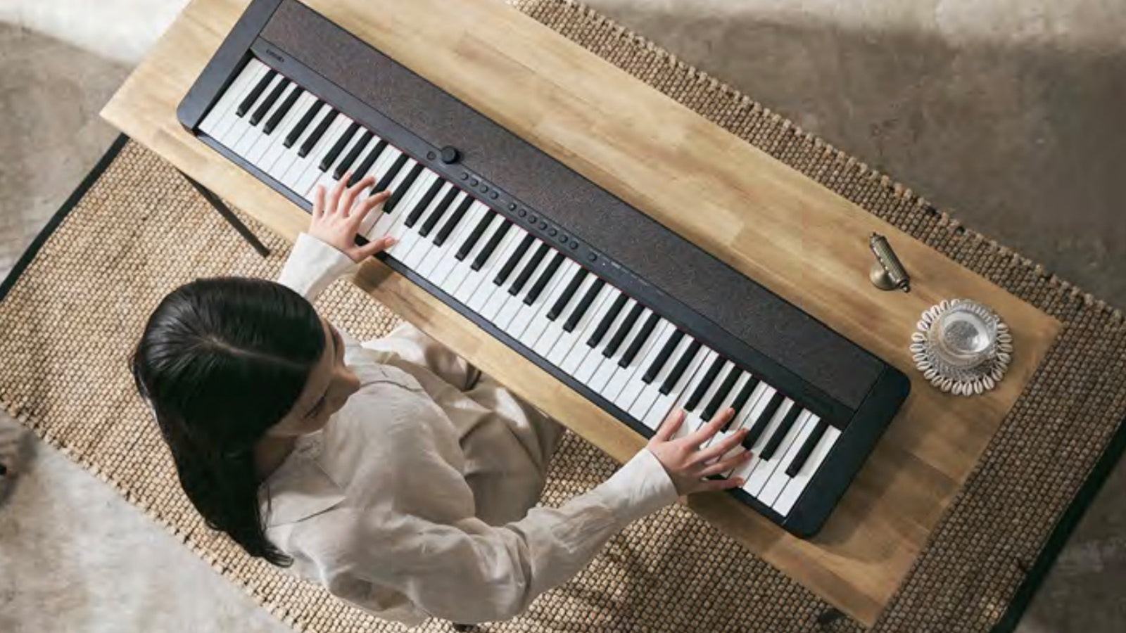 A young lady playing a Casiotone CT-S1