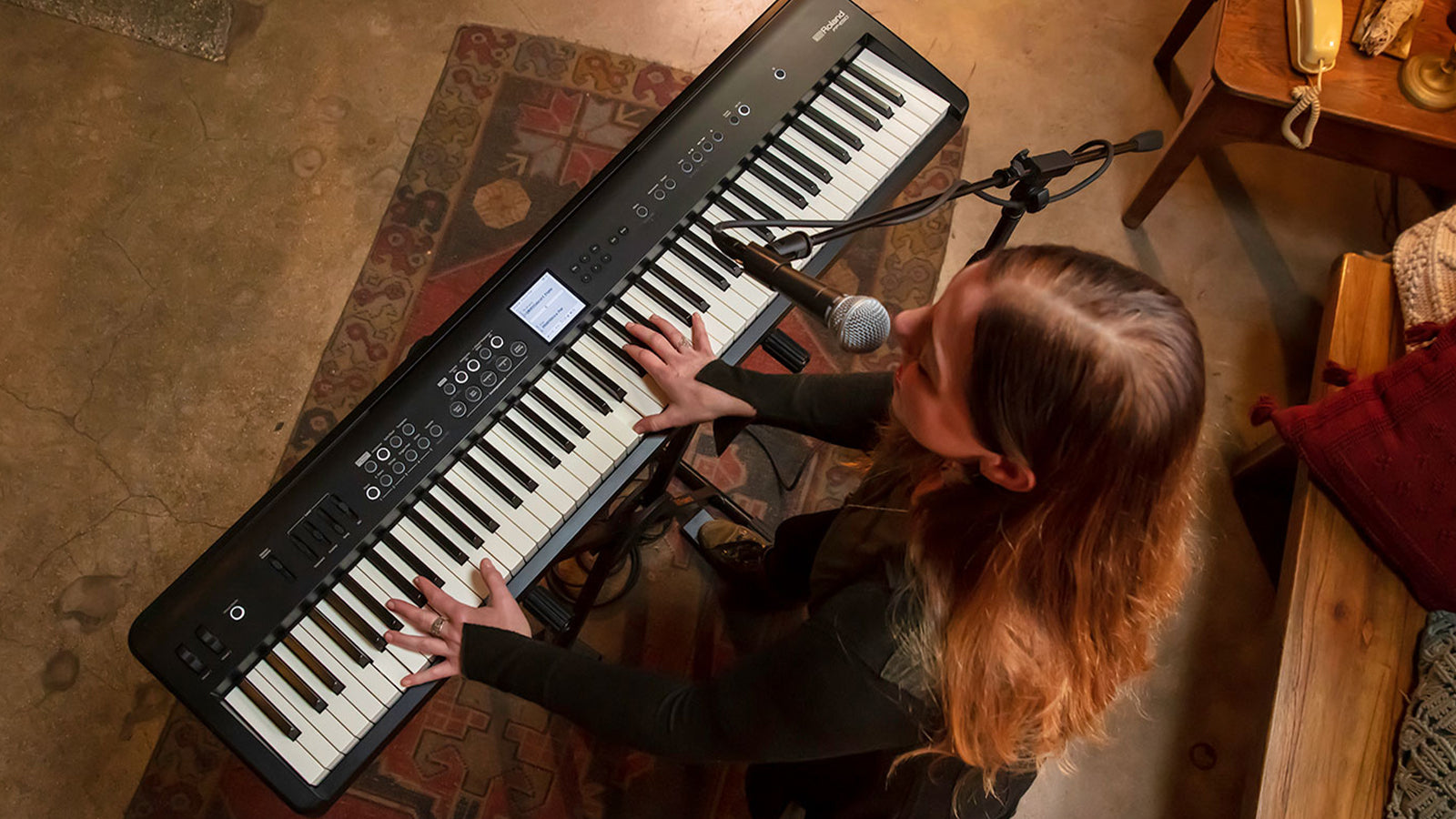 View from above of a woman playing a Roland FP-E50