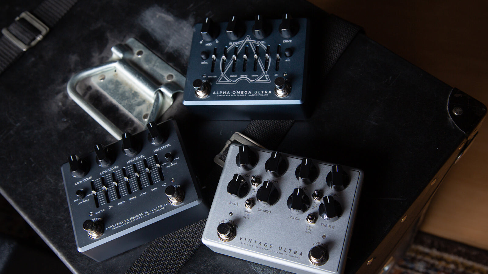 Several Darkglass pedals on a road case