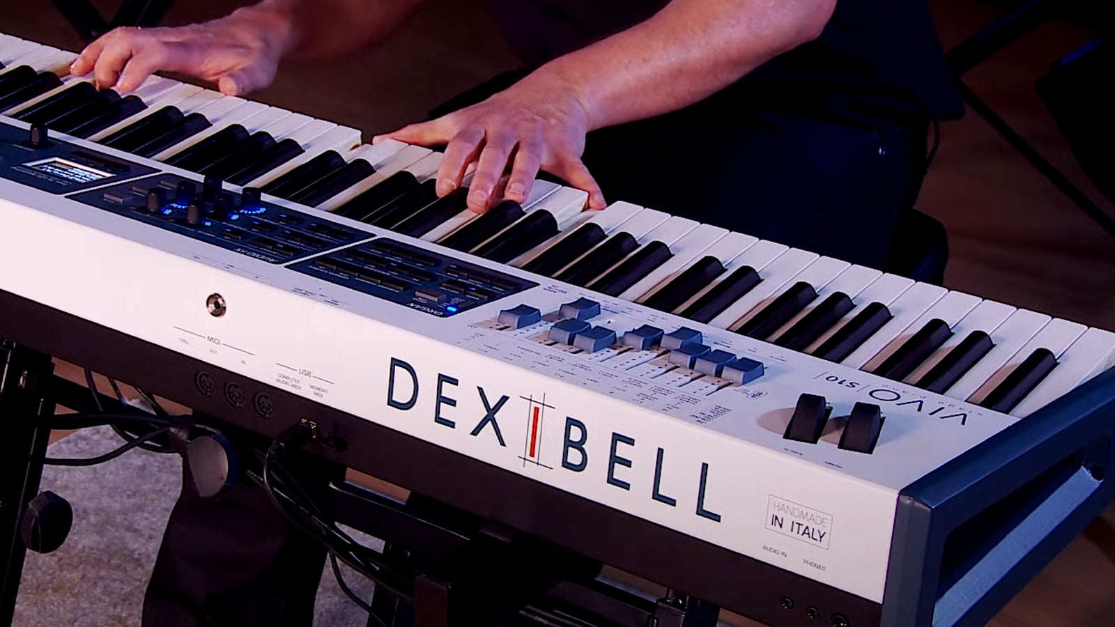 A man playing a Dexibell stage piano in a studio