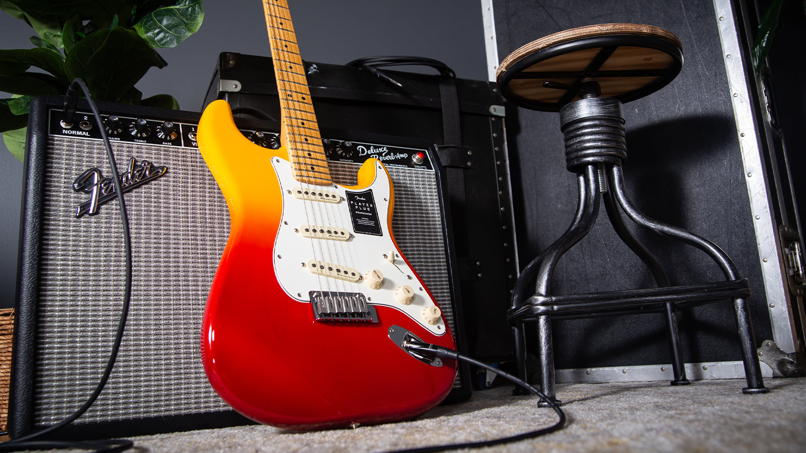 A Fender Player Plus Strat leaning against an amplifier