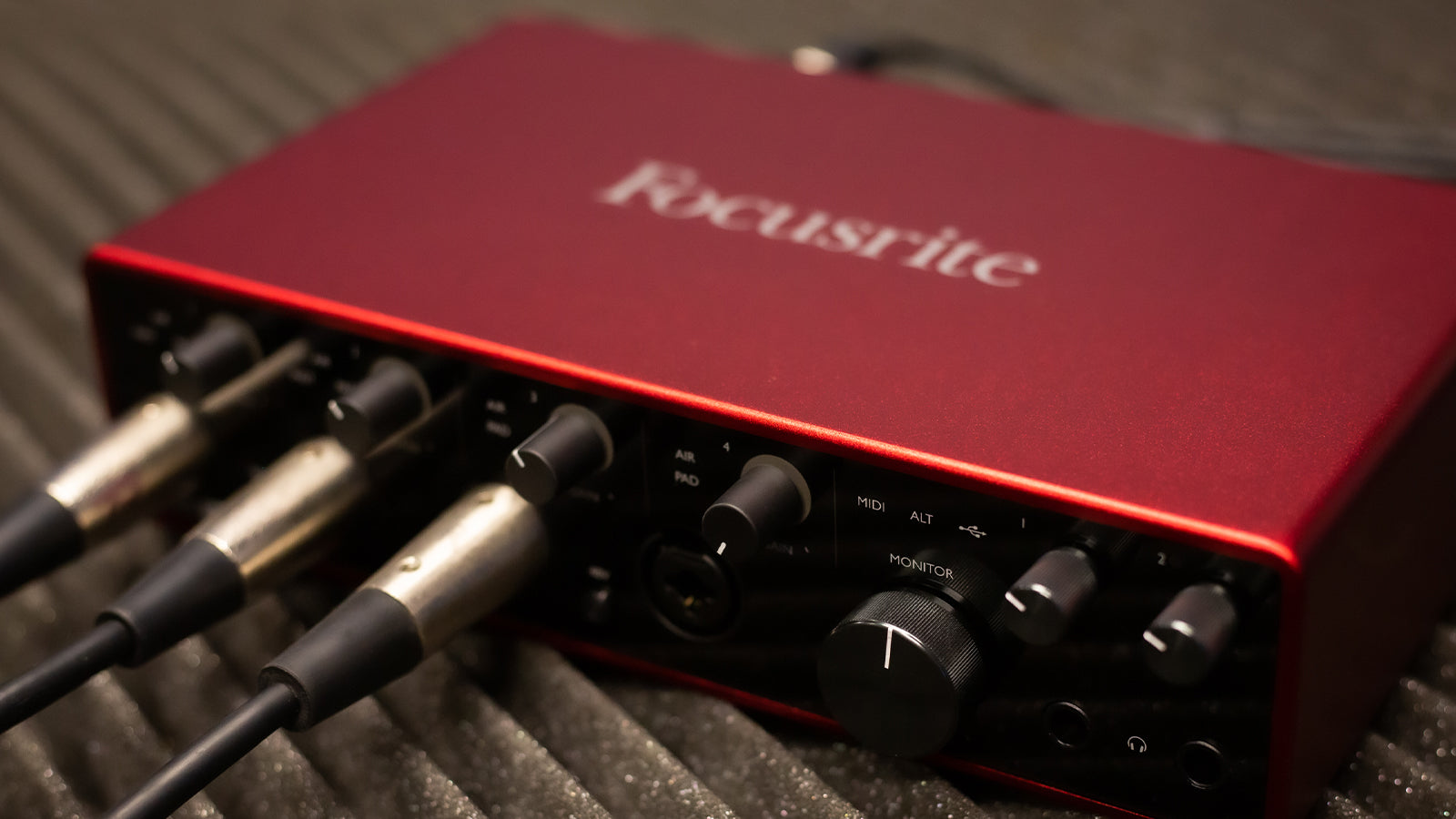 A Focusrite interface resting on some acoustic foam