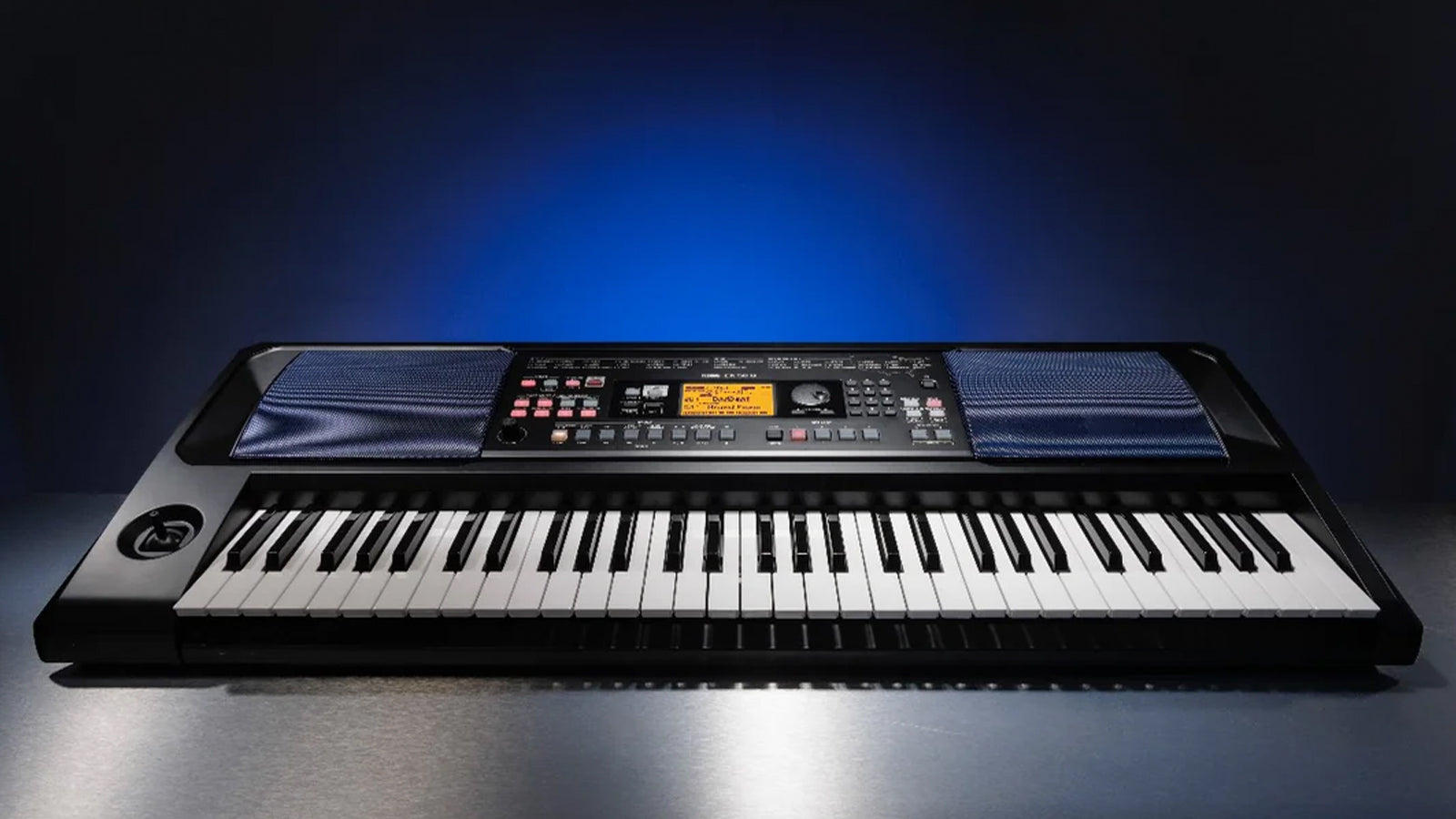 A Korg EK-50 U Entertainer Keyboard on a shinny surface with a lit blue background