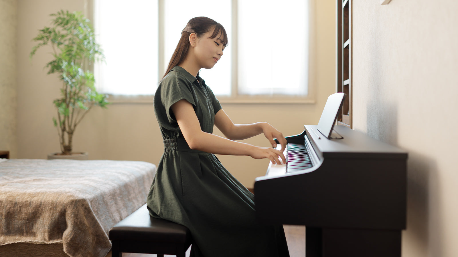 A woman playing a Kawai piano