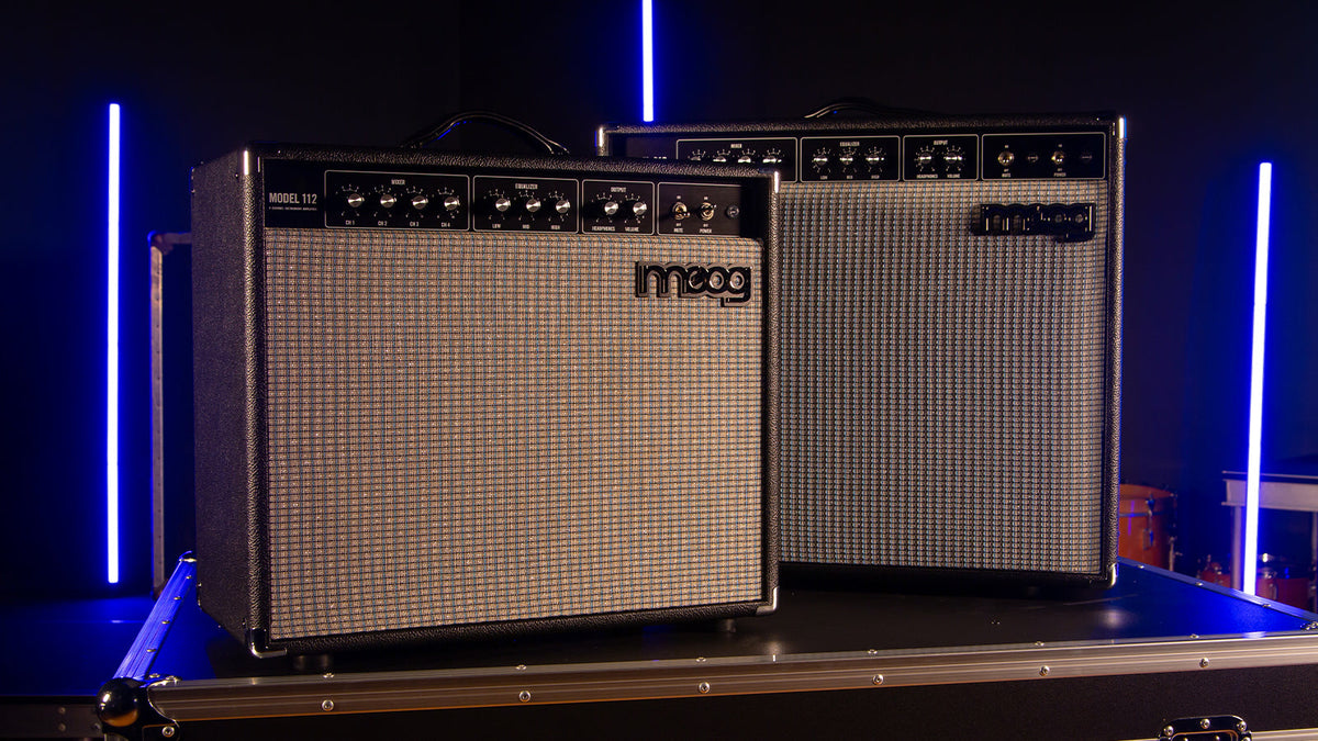 Moog Model 112 and Model 210 amplifiers sitting on a road case in a studio