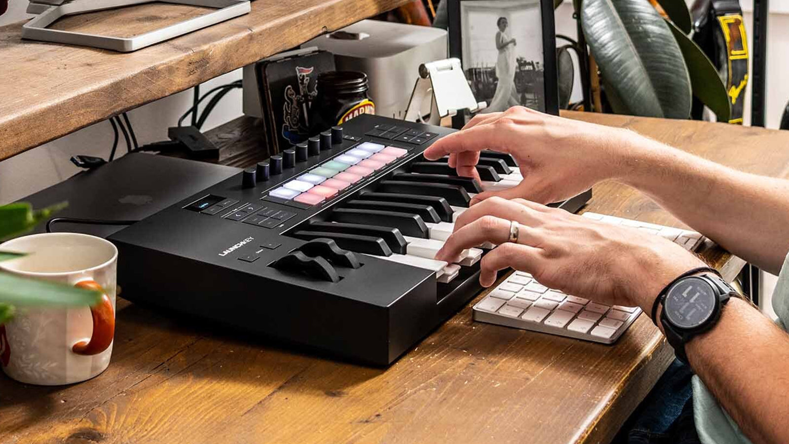 A young man using a Novation Launchkey Mk4
