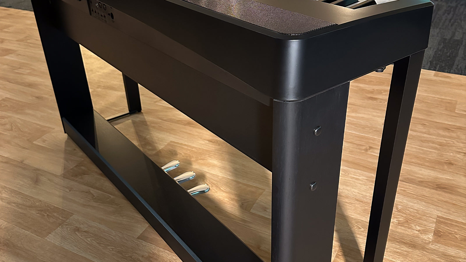 A Kawai piano on a stand in a studio