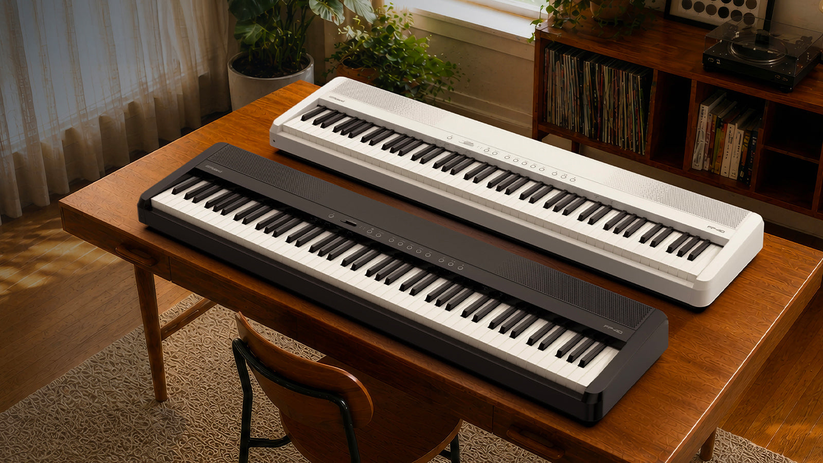 Roland FP-40 digital pianos in black and white resting on a wooden desk