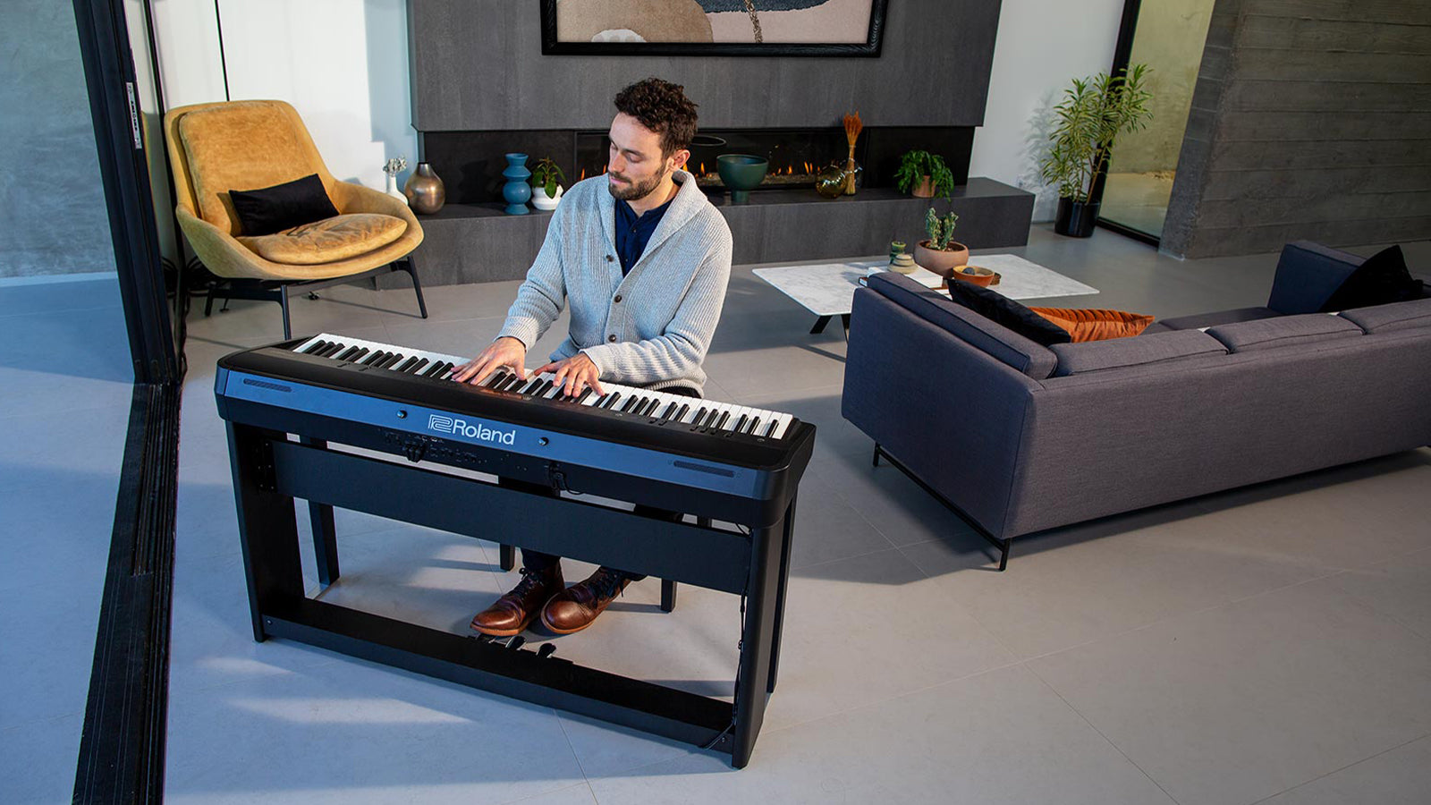 A young man playing a Roland FP-X digital piano