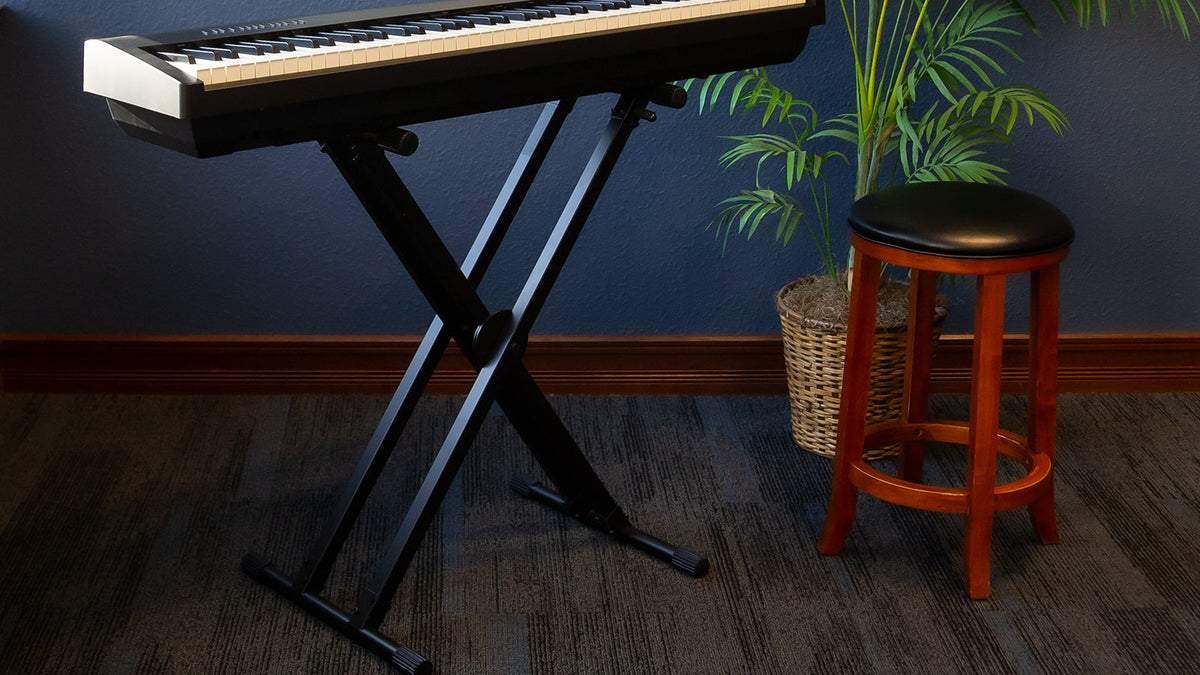 A portable piano on an On-Stage X-stand in a stylish living space